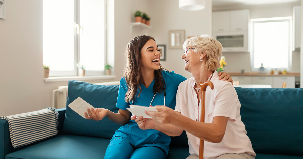 Elderly and Caregiver laughing