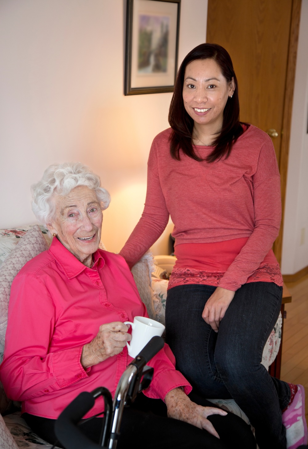 A caregiver and an older adult smile, representing the effect of quality home care in Oakland, CA.