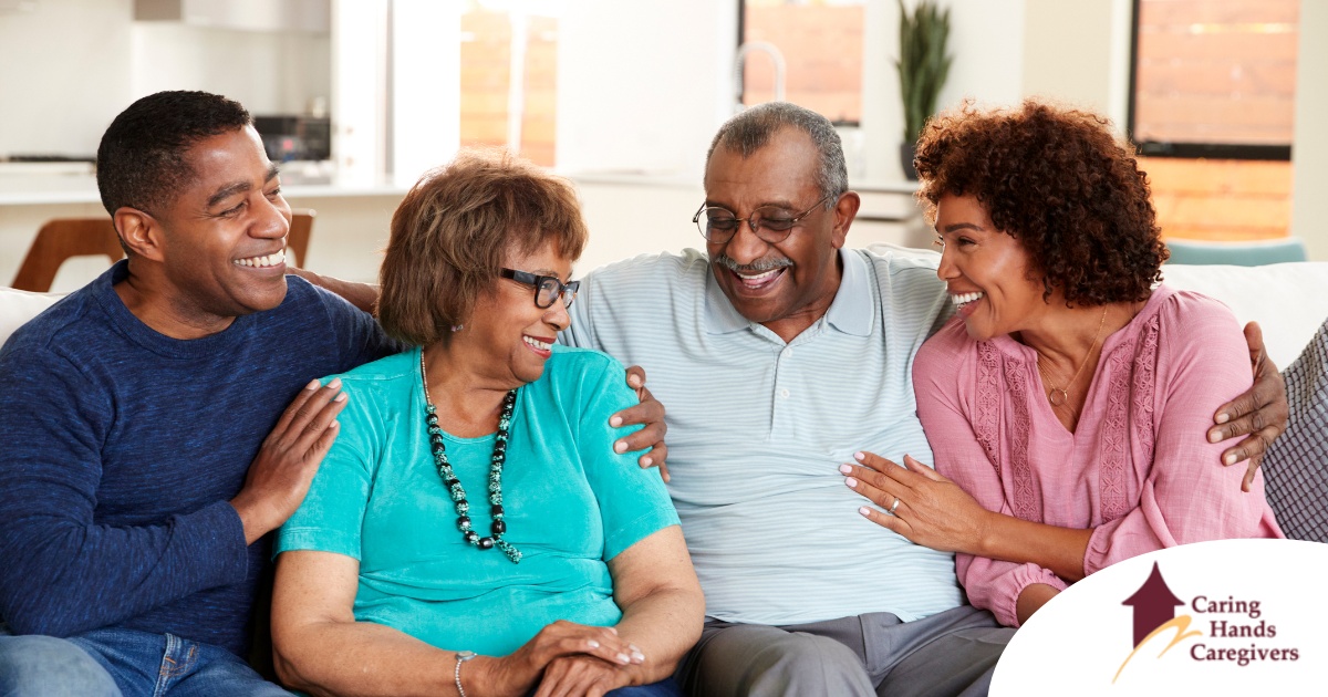 A couple sits with aging parents and enjoys their time together.
