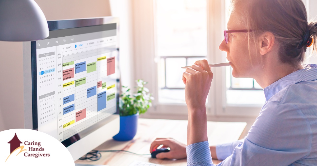 A woman looks at her calendar on her computer, showing an example of a time management tool that can help caregivers.