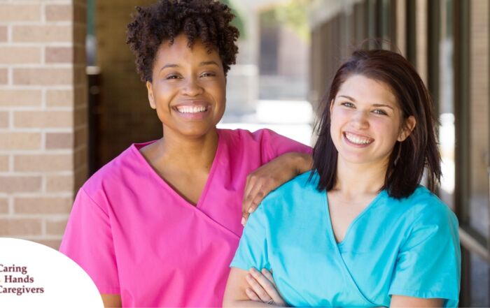 2 caregivers smile representing the good attitude that can allow home care professionals to collaborate.