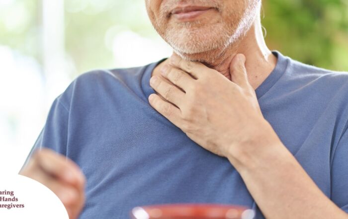 An older adult holds his throat representing dysphagia which can affect senior health.