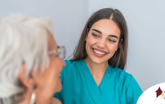 A caregiver smiles with an older client showing the results of successfully starting a new caregiving job.