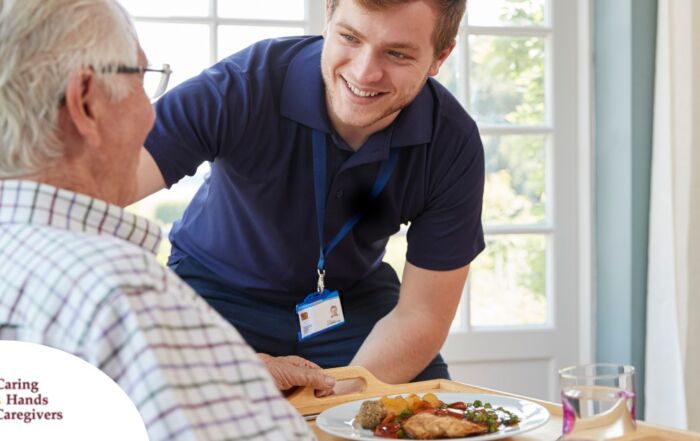 Professional caregiving involves helping clients with iADLs and ADLs as demonstrated by this caregiver helping a client by bringing a meal.