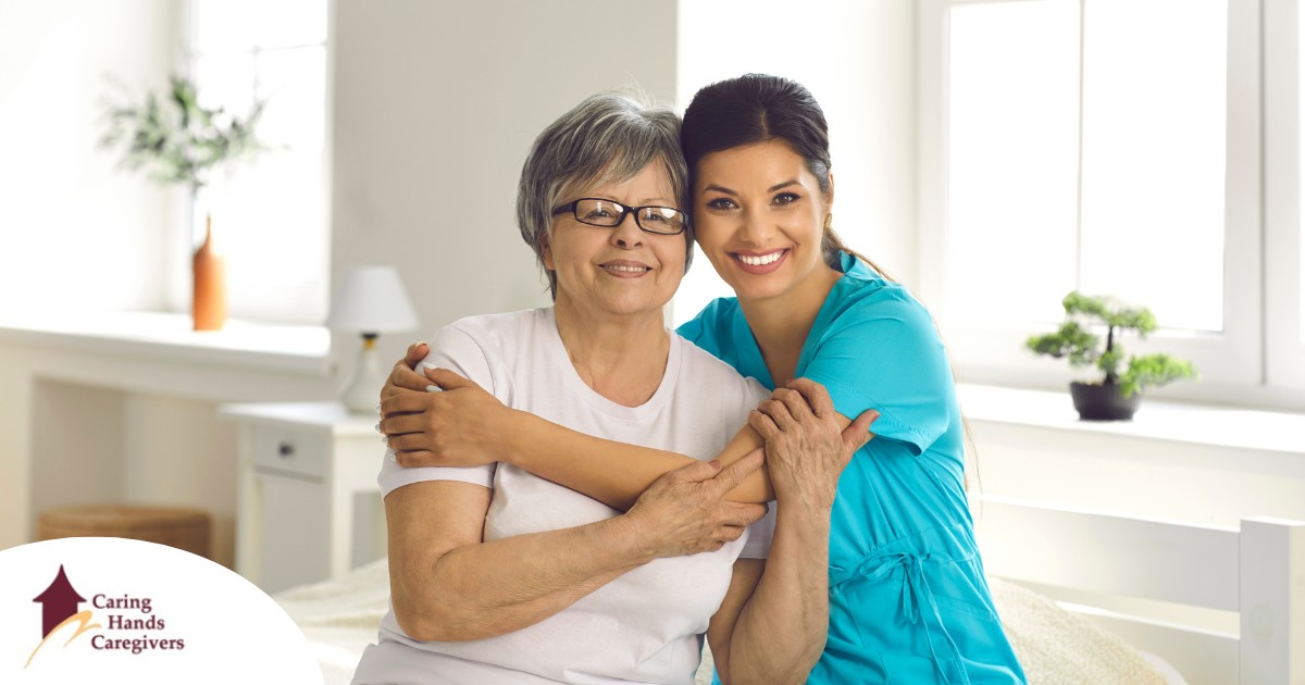 A caregiver hugs an older client, representing how a trustworthy caregiver cares for clients.