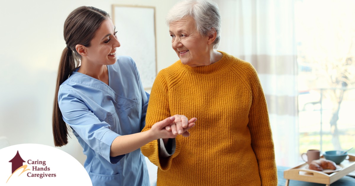 A caregiver helps a client get around, demonstrating one of the job duties of a caregiver.