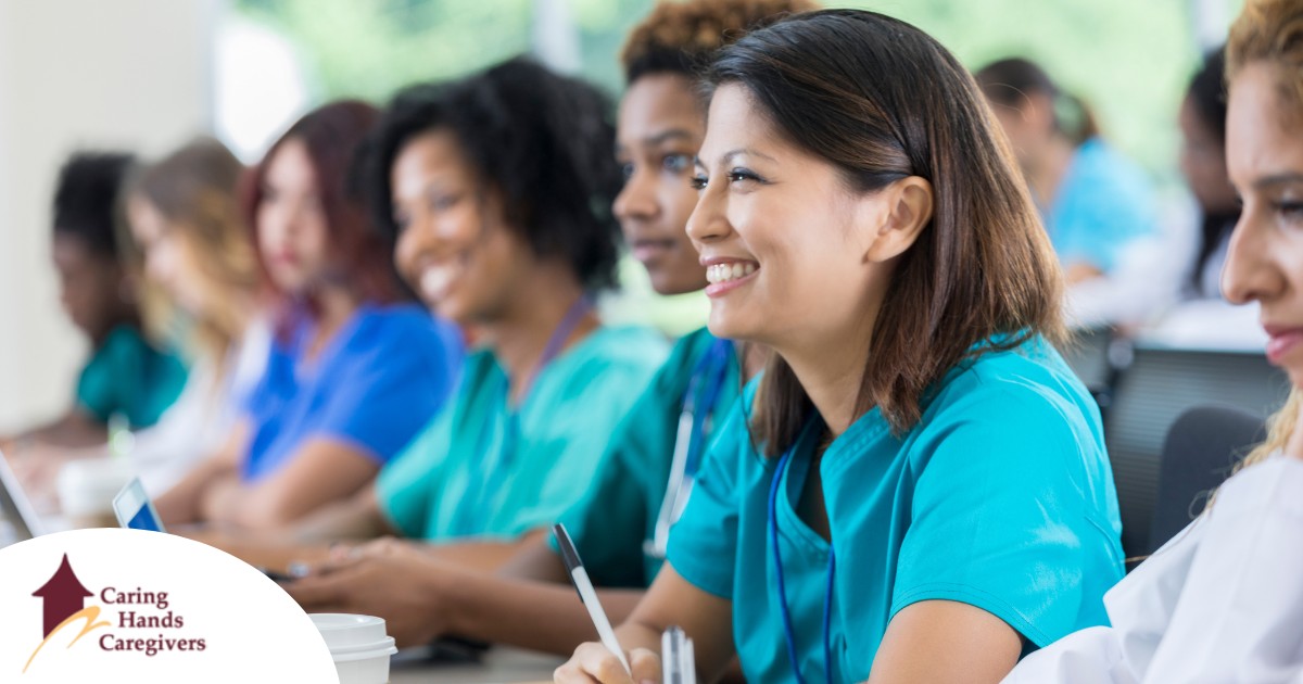 From Basics to Expertise The Journey of Caregiver Training Several students in scrubs happily attend a class, representing caregiver training.