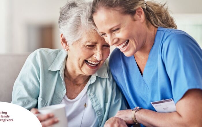 A woman in scrubs laughs with a senior woman, representing how caregiving can be a great career choice.