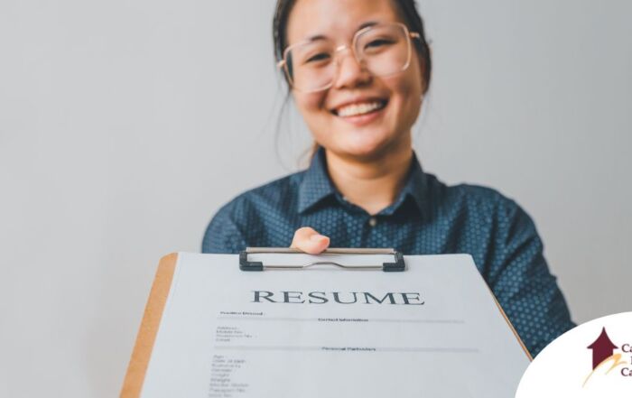A woman happily hands in a resume, representing a successfully written caregiver resume.