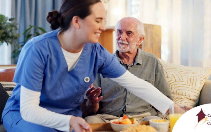 Caregiver providing senior care at home to manage parkinson’s and related symptoms.