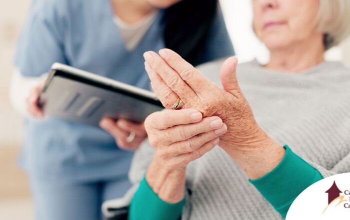 A caregiver provides in home care services to a senior with arthritis