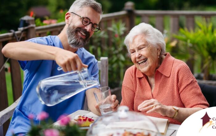 A caregiver applies summer Caregiving Tips including helping a senior stay hydrated.