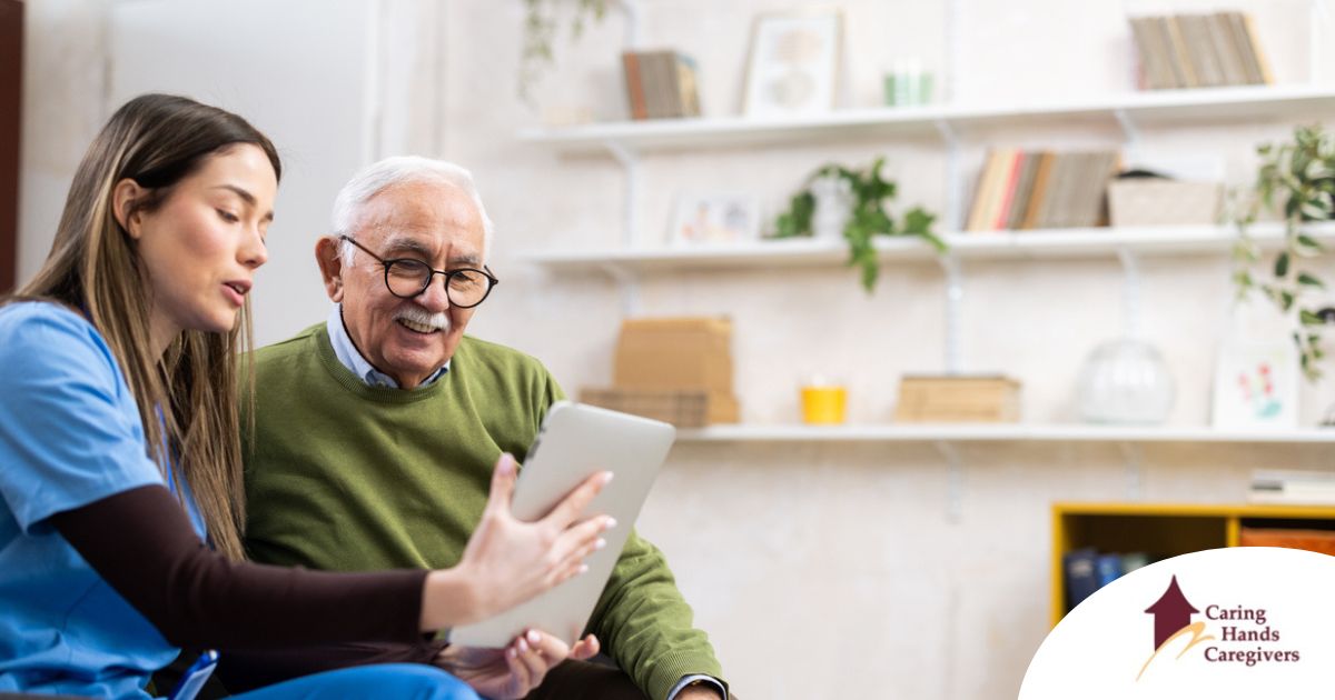 Telehealth and Senior Care Home caregiver assisting senior man to use telehealth and senior care